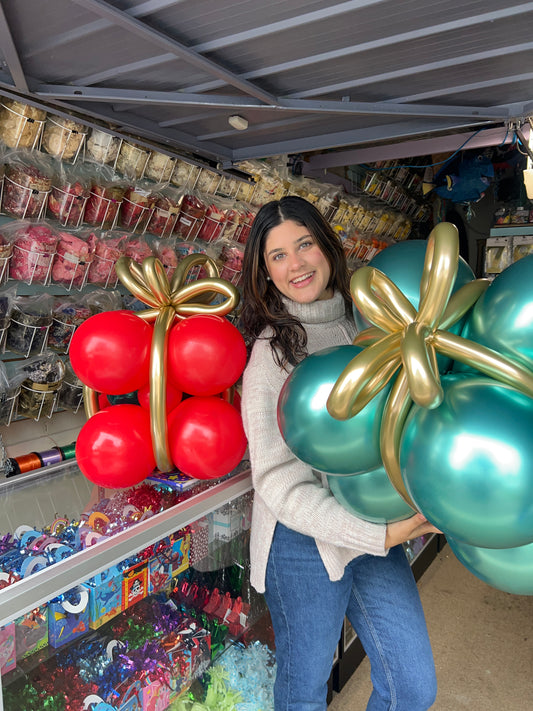 Close-up of freestanding Christmas balloon gifts featuring two additional balloon presents in a holiday-themed design.
