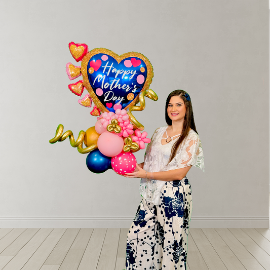Balloon heart stand for Mother’s Day with blue heart, mini pink hearts, floral accents, and hand-shaped base