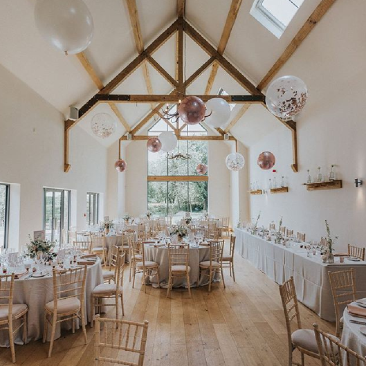Suspended Floating Balloon Installation with giant and orbz balloons in a stunning event venue.