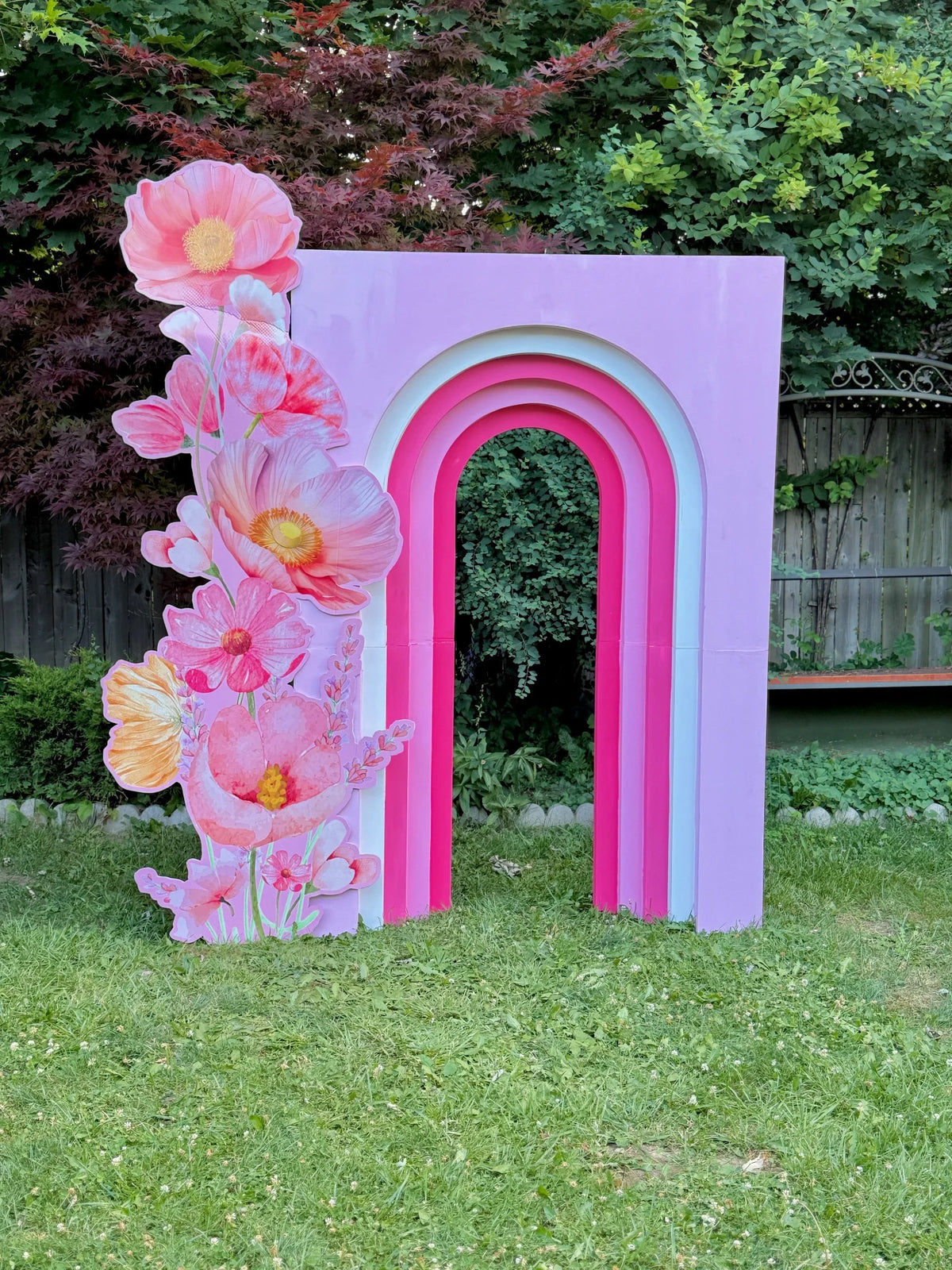 Birthday rainbow arch balloon backdrop in pastel pink tones β event decor and rentals in Toronto by Wooow Balloons.
