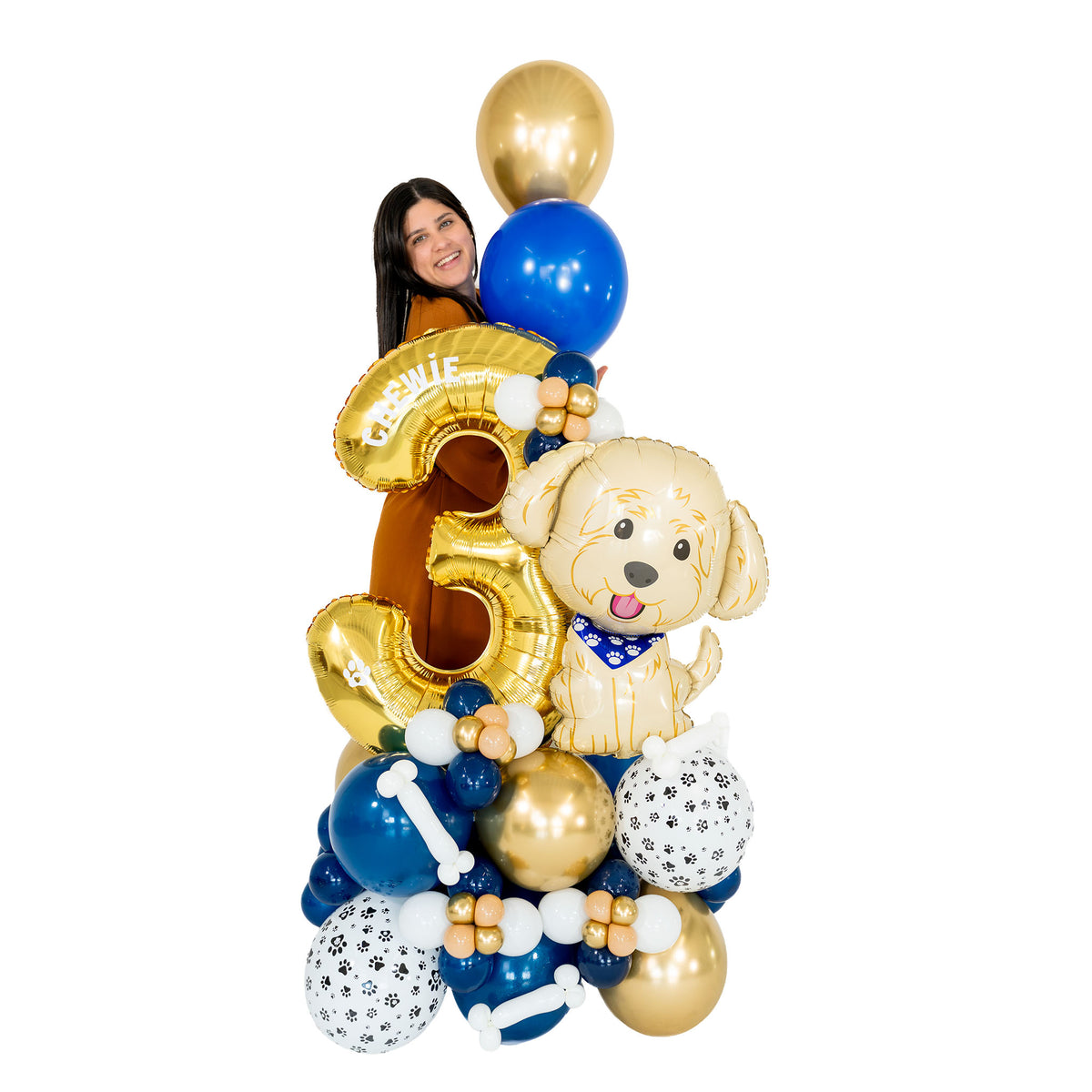Woman standing behind a personalized puppy birthday balloon arrangement with a gold number 3, showing the scale of the blue, white and gold design.
