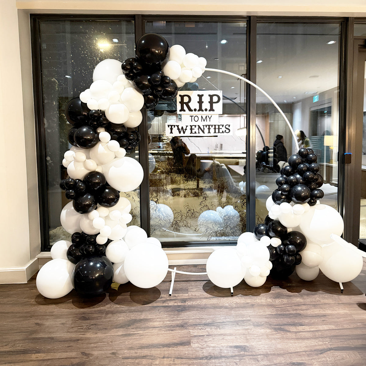 Milestone 30th birthday balloon installation Toronto with custom black and white styling