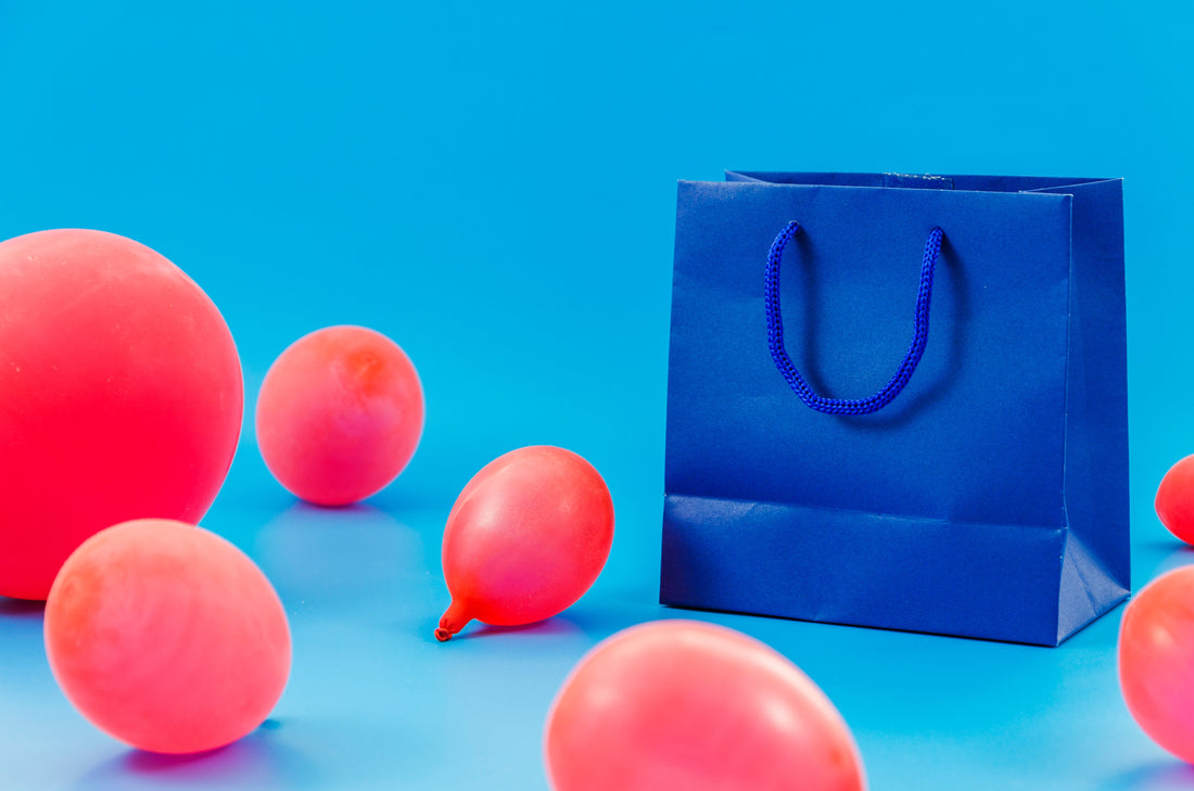 Birthday gift bag with colourful balloons for celebration decor inspiration