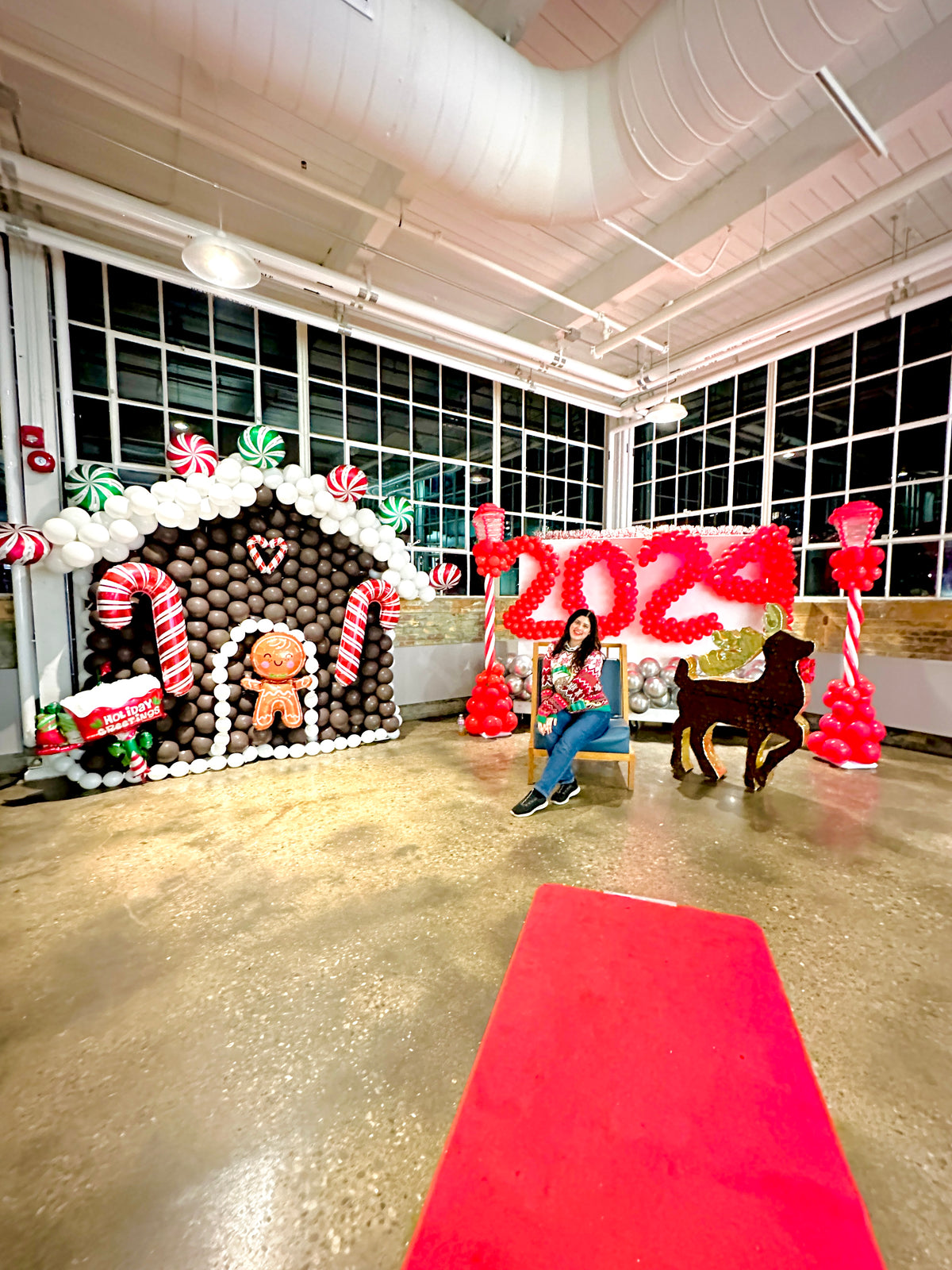Christmas Balloon Numbers and Light Stands Decor with festive candy cane accents and gingerbread house backdrop.