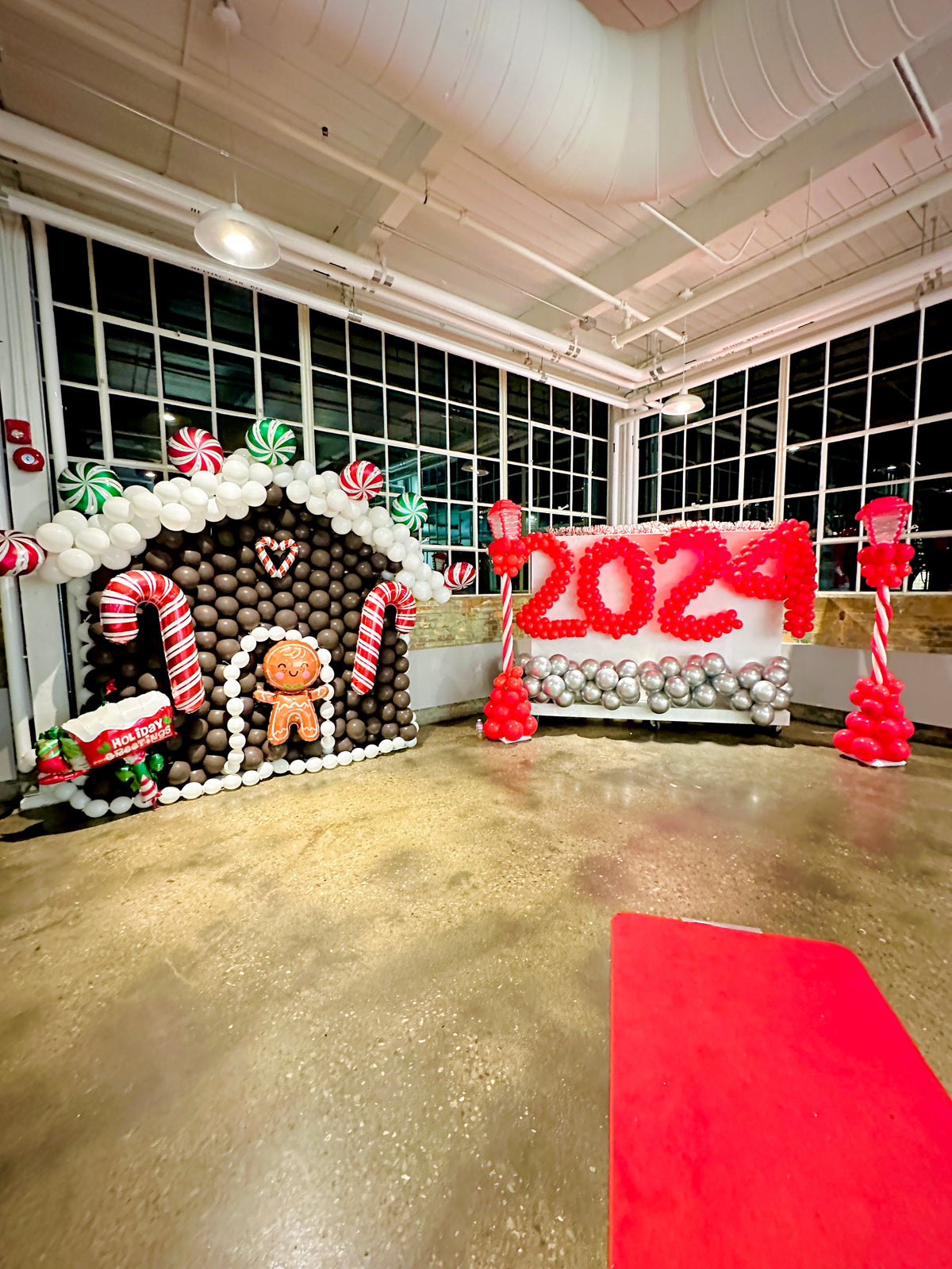 Christmas Balloon Numbers and Light Stands Decor with festive candy cane accents and gingerbread house backdrop.