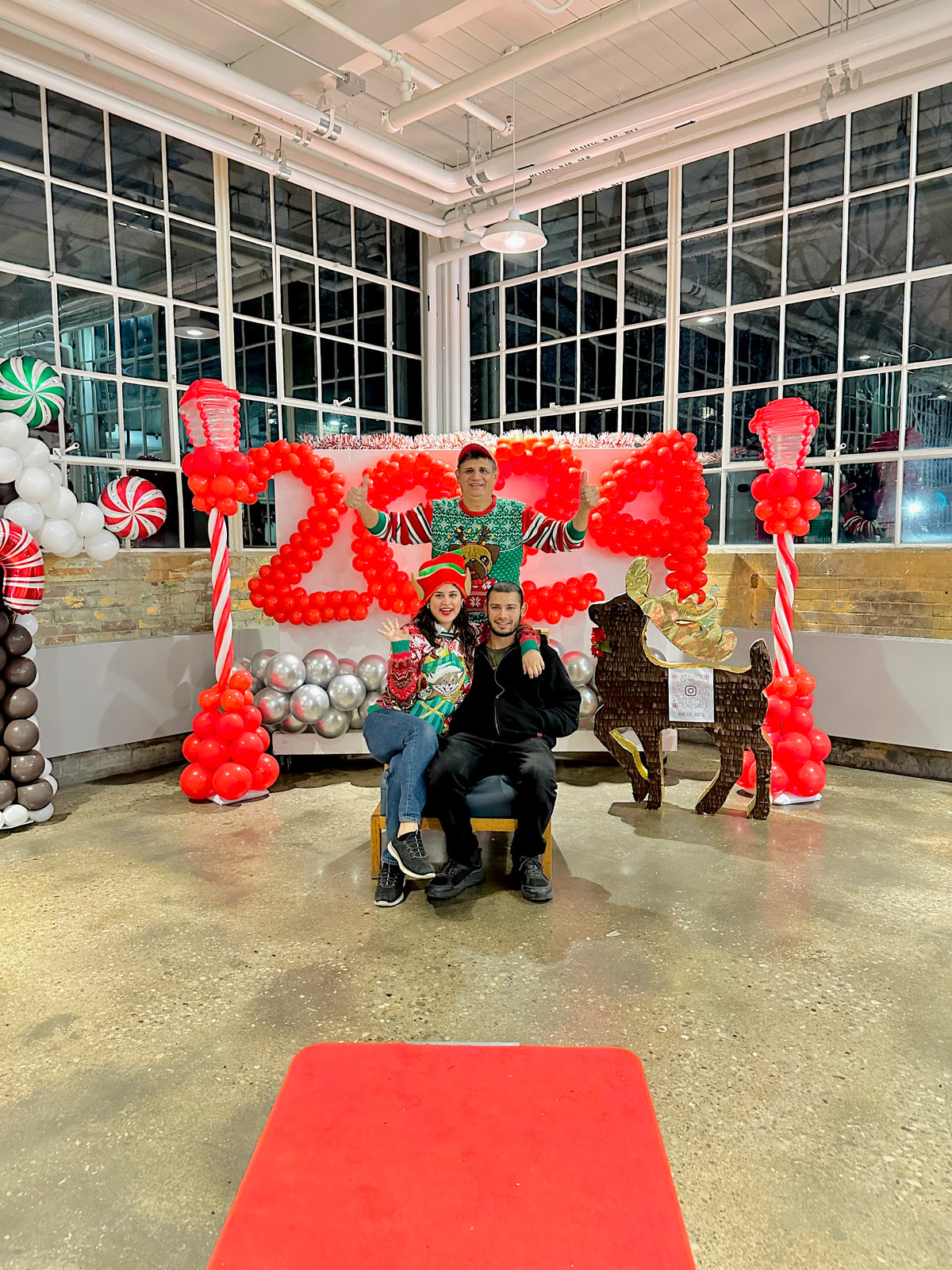 Christmas Balloon Numbers and Light Stands Decor with festive candy cane accents and gingerbread house backdrop.