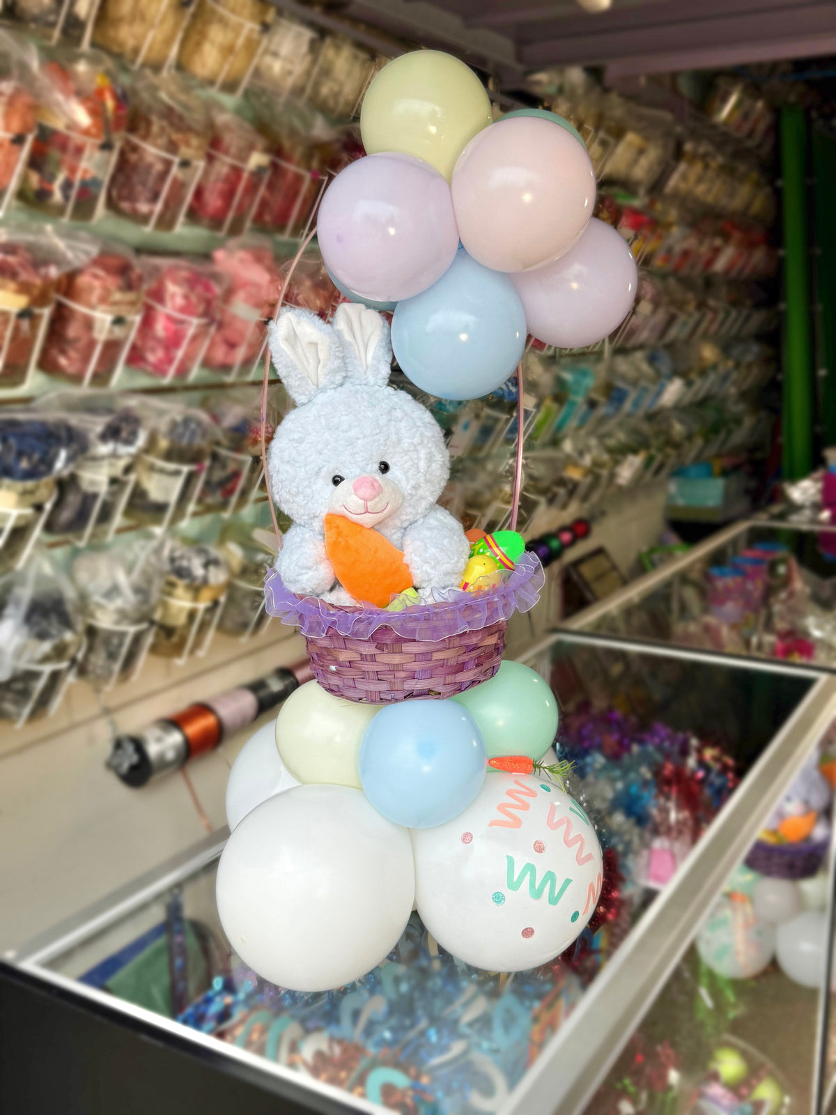 Decorative display with a bunny and balloons in a store setting