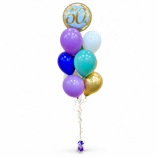 50th birthday balloon bouquet with purple, blue, teal and gold balloons and a round 50th foil topper by Wooow Balloons in Toronto.