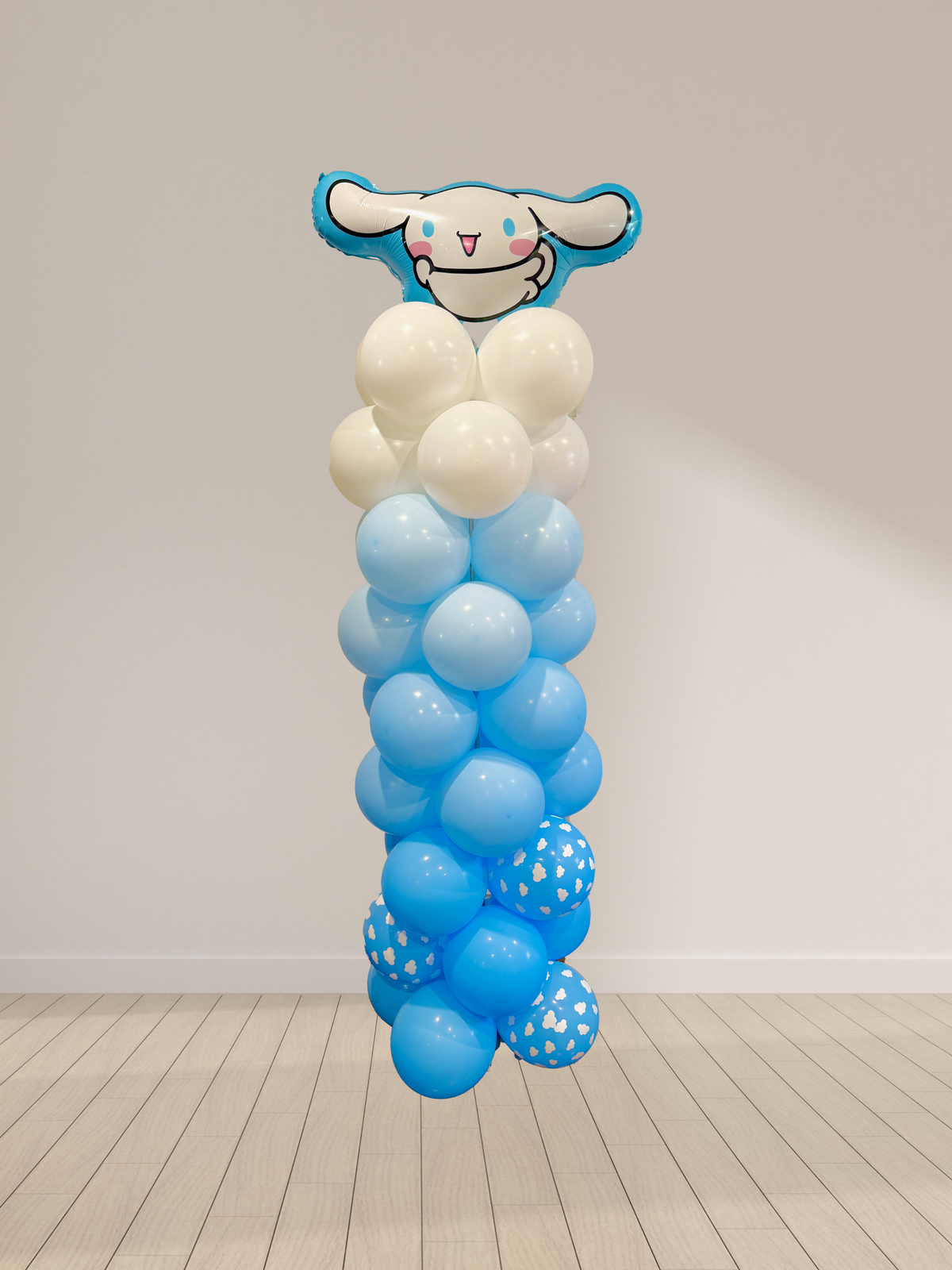 Balloon sculpture of a cartoon character with blue and white balloons on a plain background