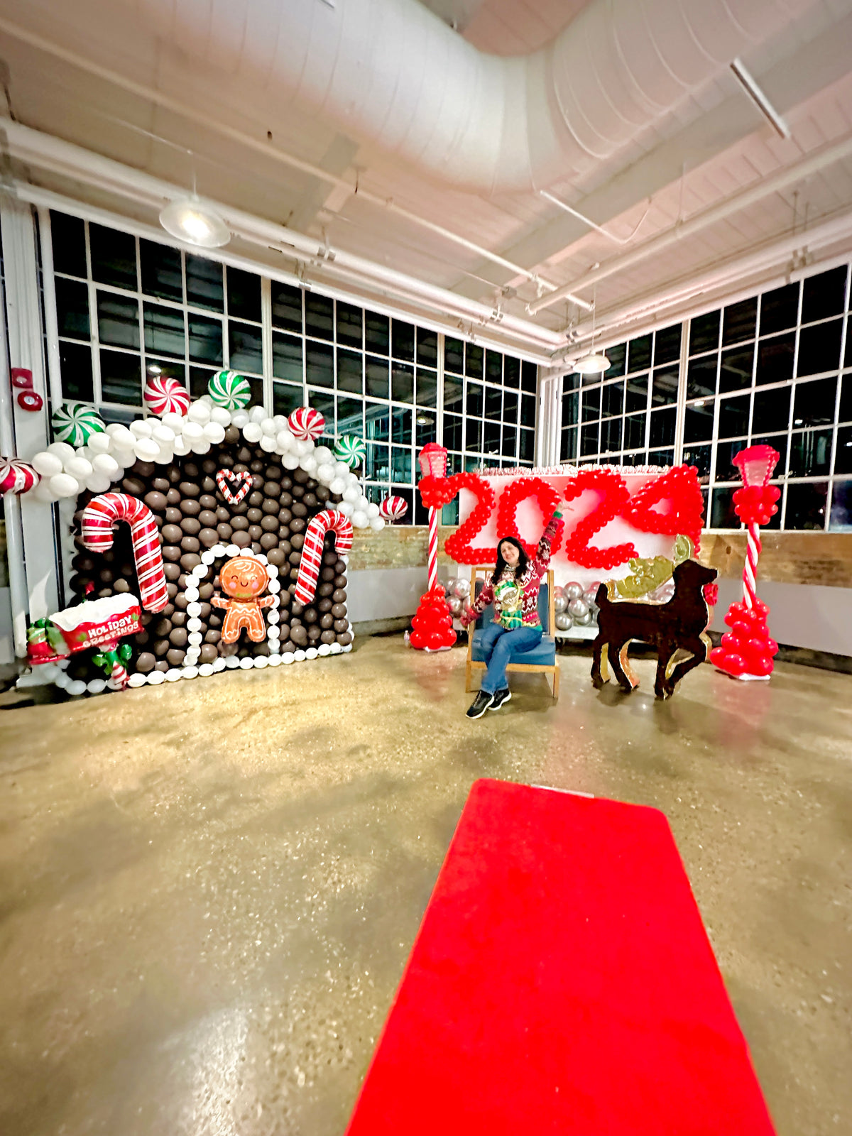 Christmas Balloon Numbers and Light Stands Decor with festive candy cane accents and gingerbread house backdrop.