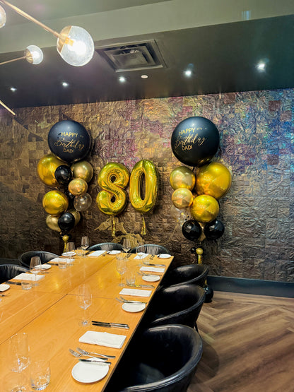 Decorated dining room with balloons for a 80th birthday celebration.