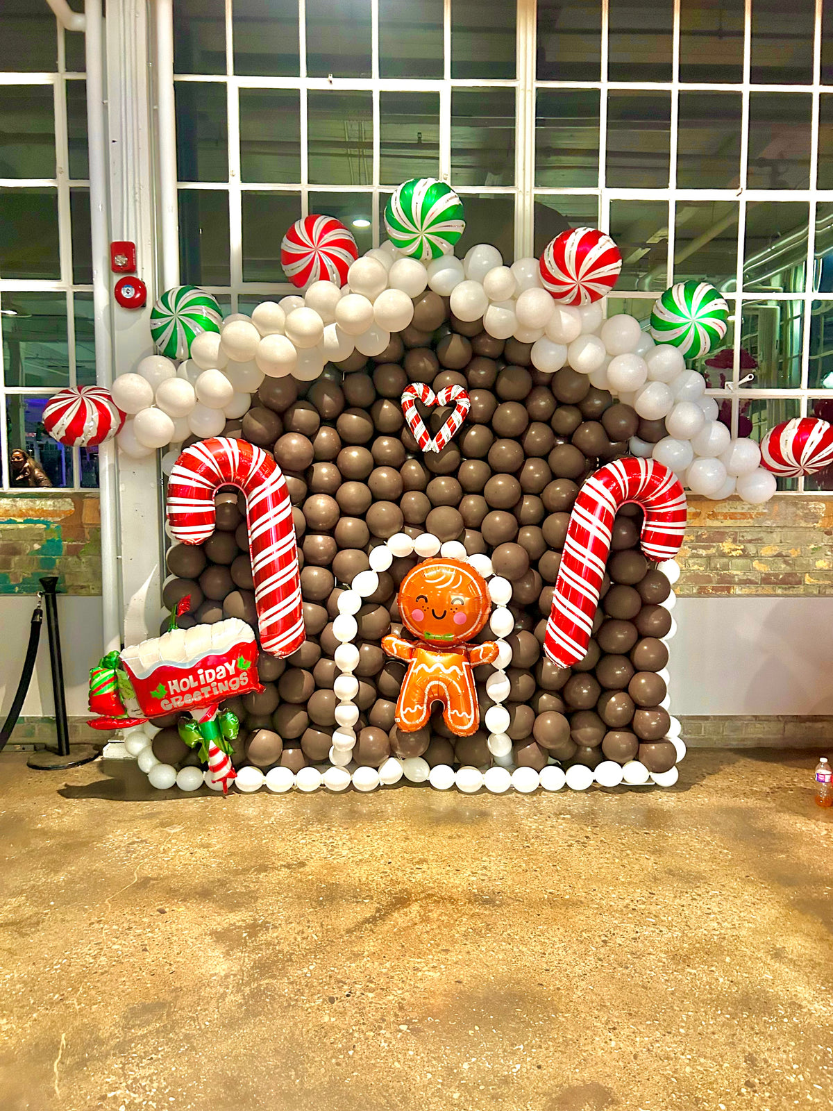Gingerbread Balloon House with festive balloons and holiday decorations.