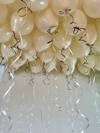 Coquette Balloons with helium-filled biodegradable balloons and decorative bows.

