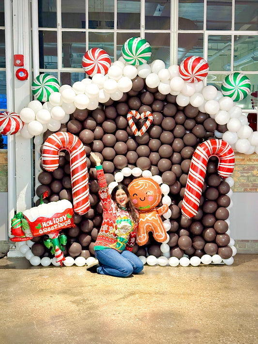 Gingerbread Balloon House with festive balloons and holiday decorations.