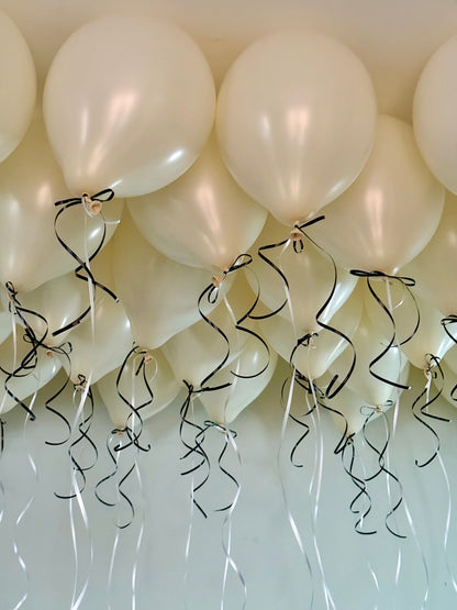 Coquette Balloons with helium-filled biodegradable balloons and decorative bows.

