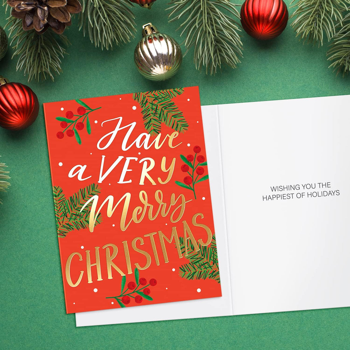 Christmas card with festive text and decorations on a green background