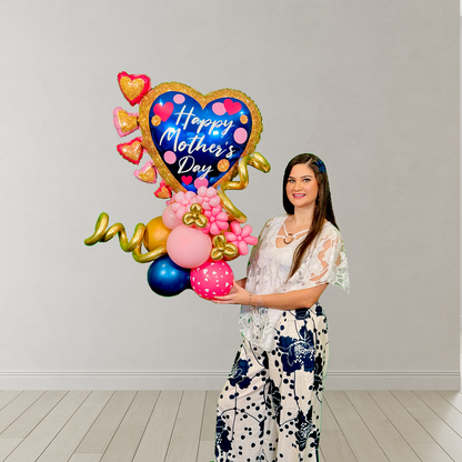 Balloon heart stand for Mother’s Day with blue heart, mini pink hearts, floral accents, and hand-shaped base