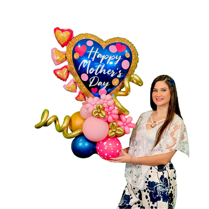 Luxury Mother’s Day balloon bouquet with blue heart “Happy Mother’s Day” balloon, gold accents, and pink floral balloons, held by model on white background, Toronto same day delivery