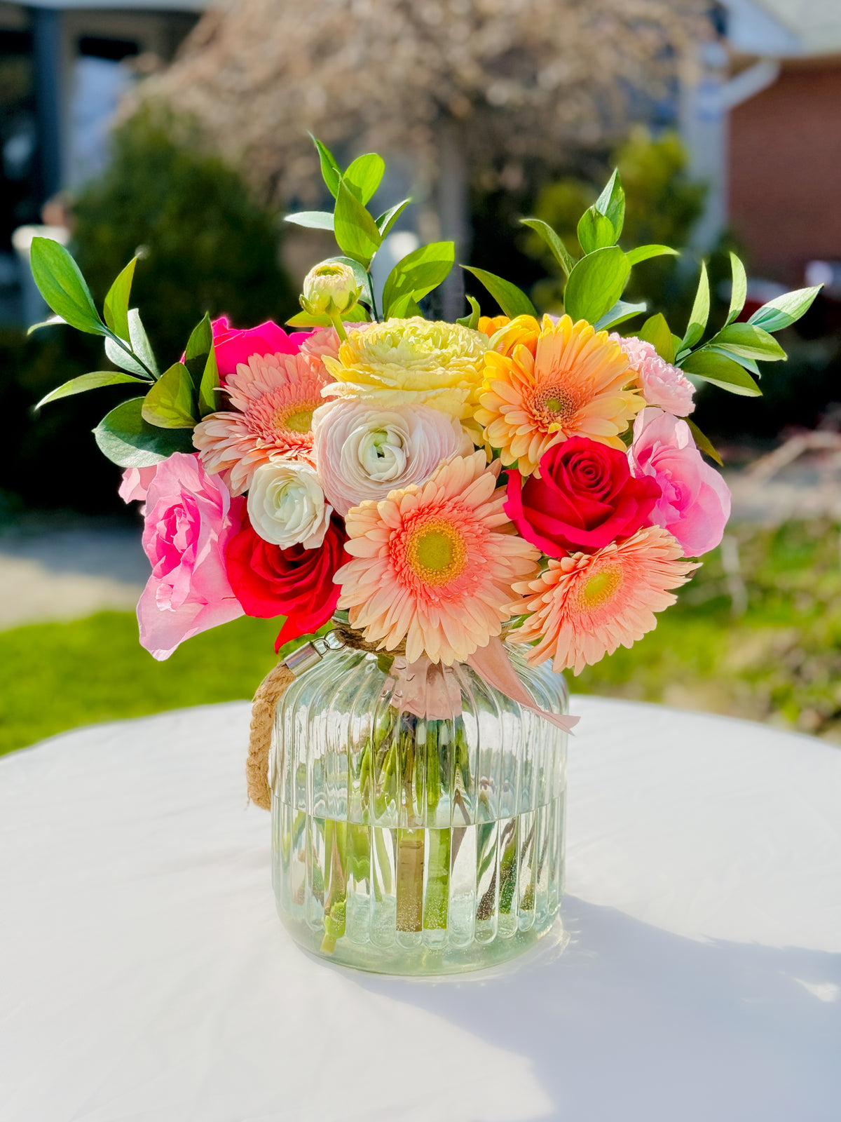 Hand-tied Mother’s Day flower bouquet with gerberas and seasonal blooms – jar not included