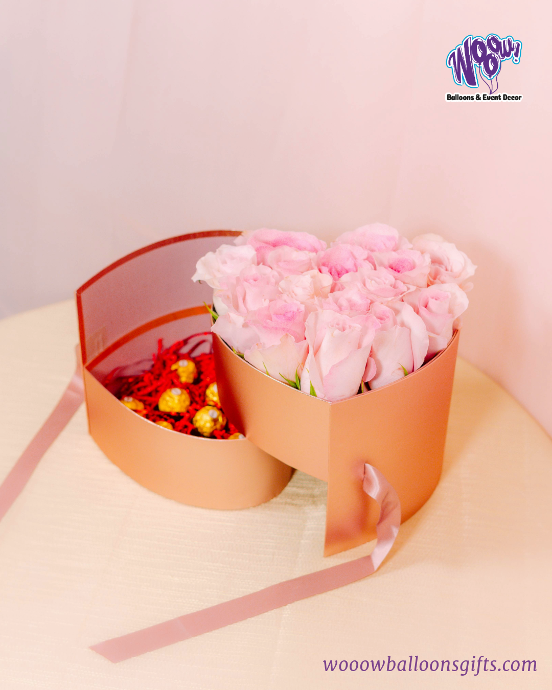 Rose Gold Heart Box with fresh pink roses and Ferrero Rocher chocolates in a luxurious rose gold heart-shaped box.