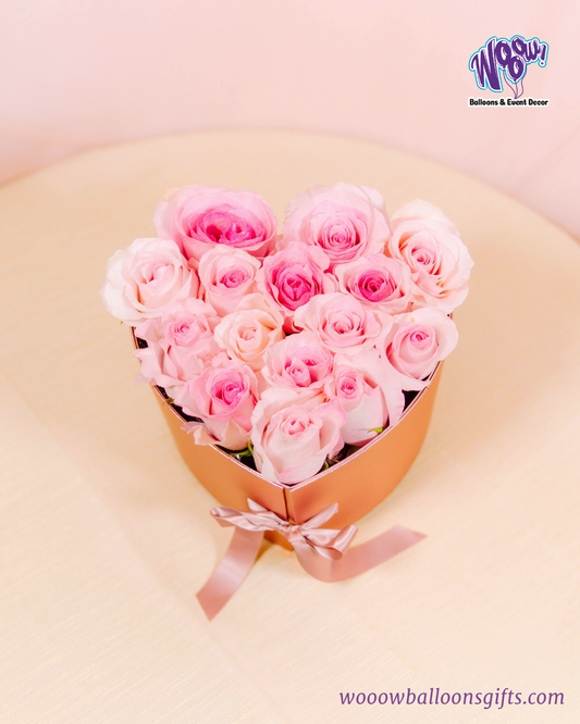 Rose Gold Heart Box with fresh pink roses and Ferrero Rocher chocolates in a luxurious rose gold heart-shaped box.