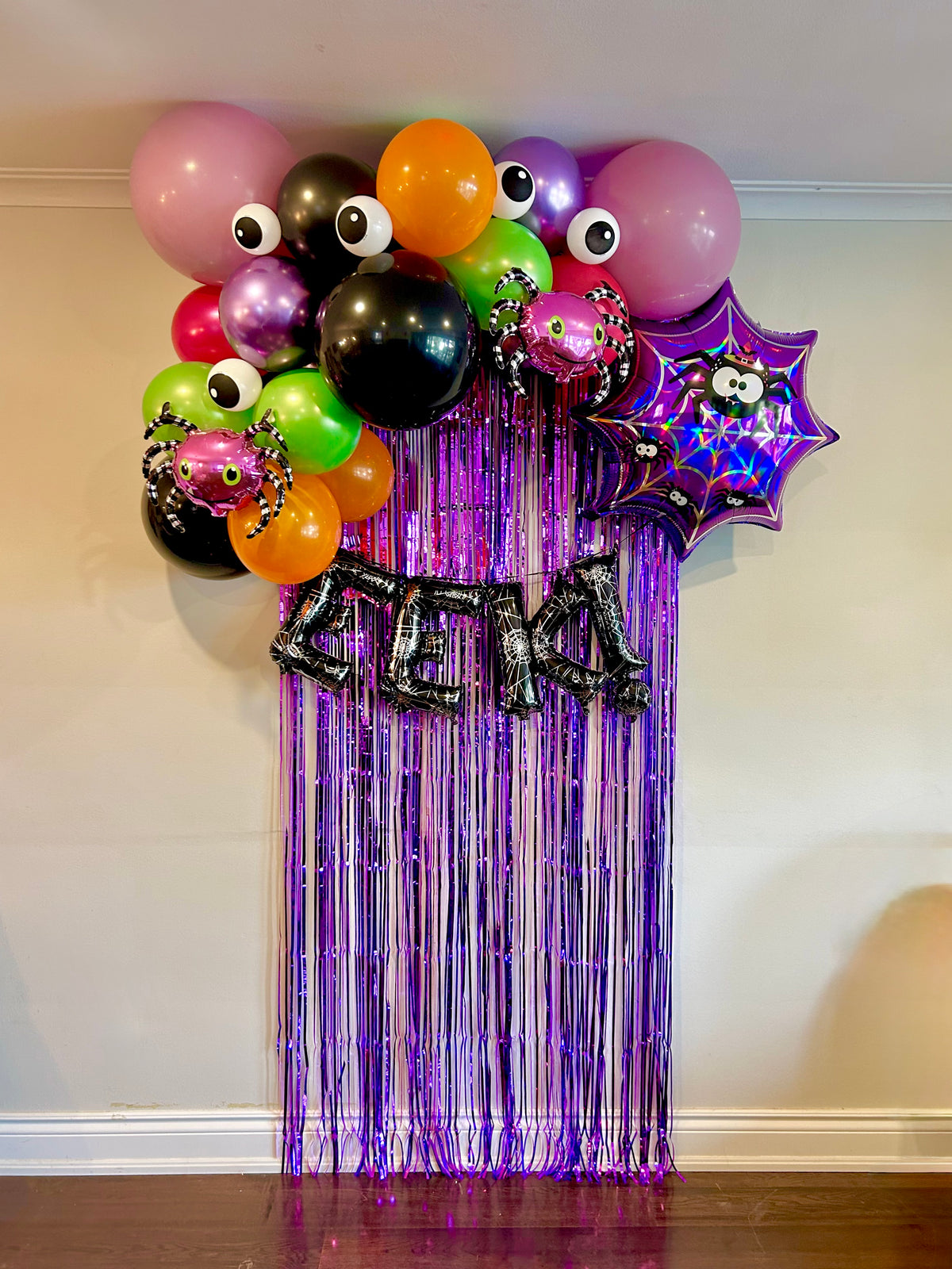 Spider Halloween Balloon Decor with spooky balloons, spider web foil, and party curtain