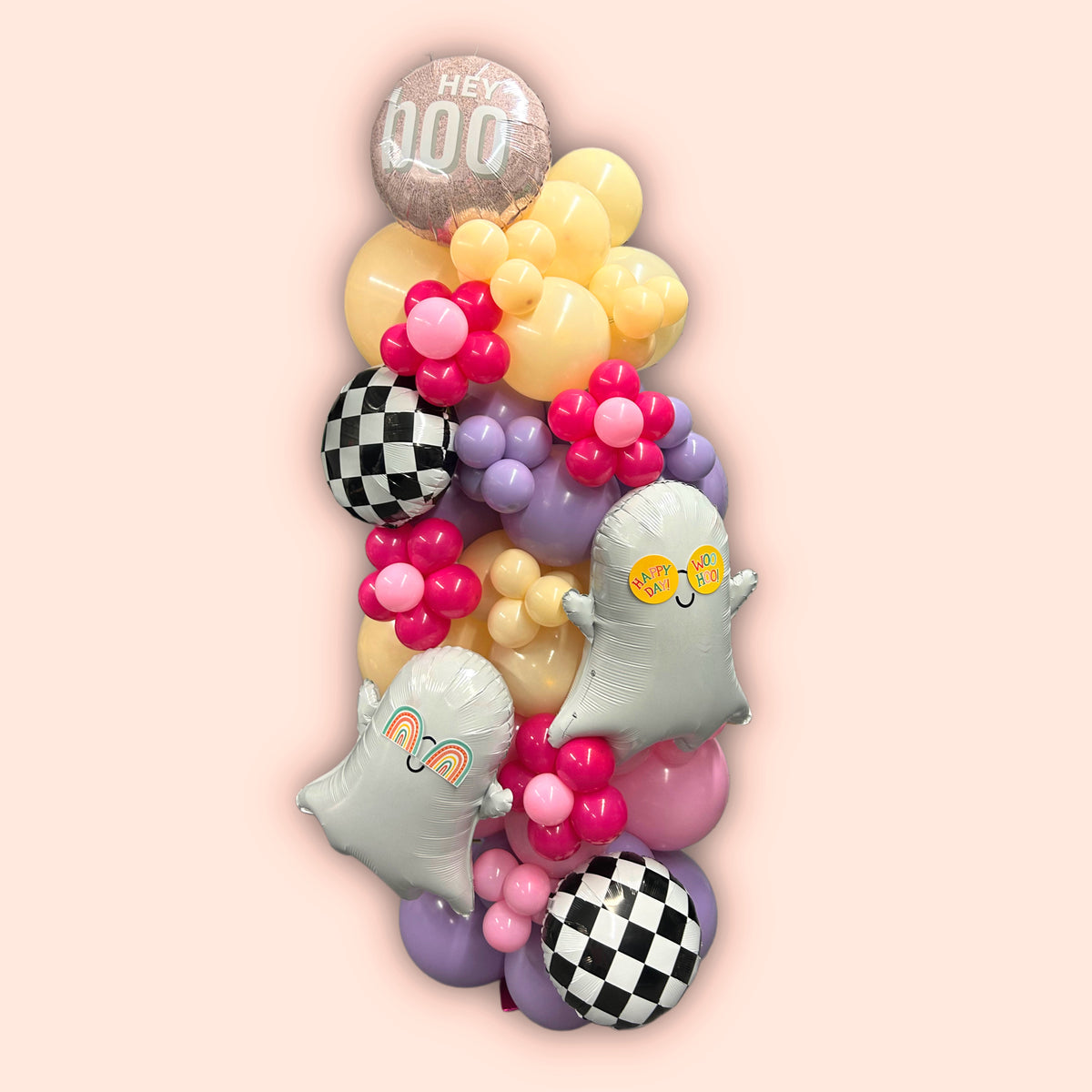 Spooky Chic Balloon Tower with ghost balloons, pastel colors, checkered accents, and a "Hey Boo" topper for Halloween celebrations.