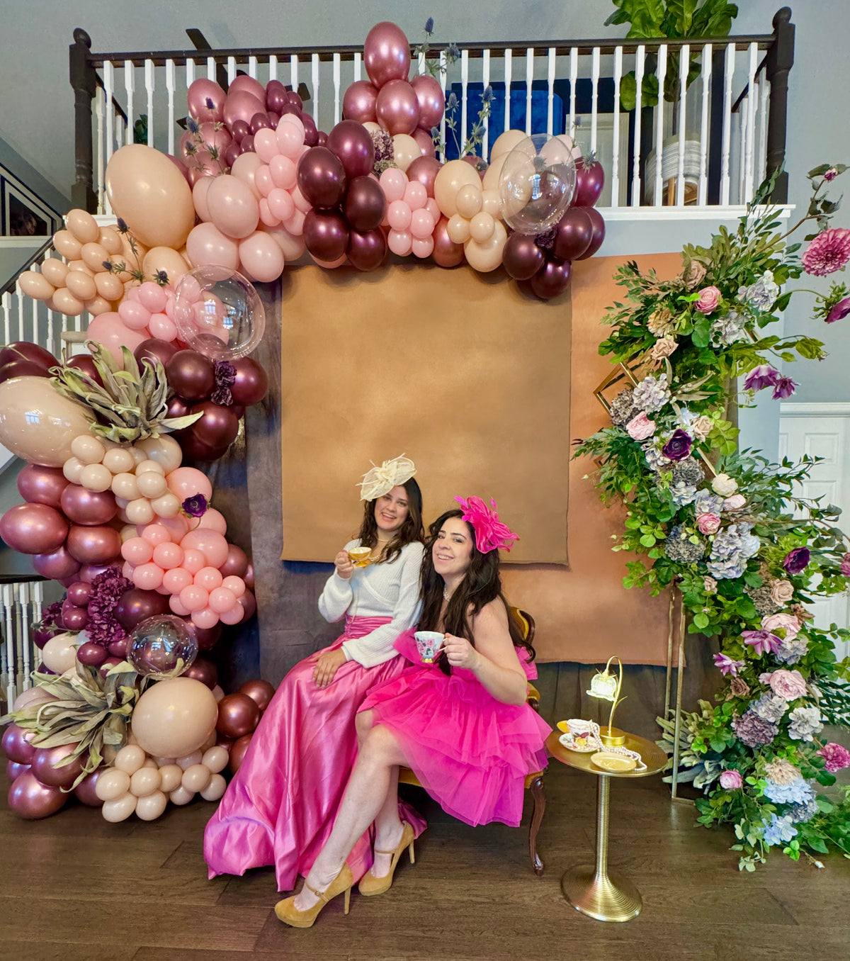 Luxury spring floral balloon garland with blush, gold, and greenery for elegant event decor.