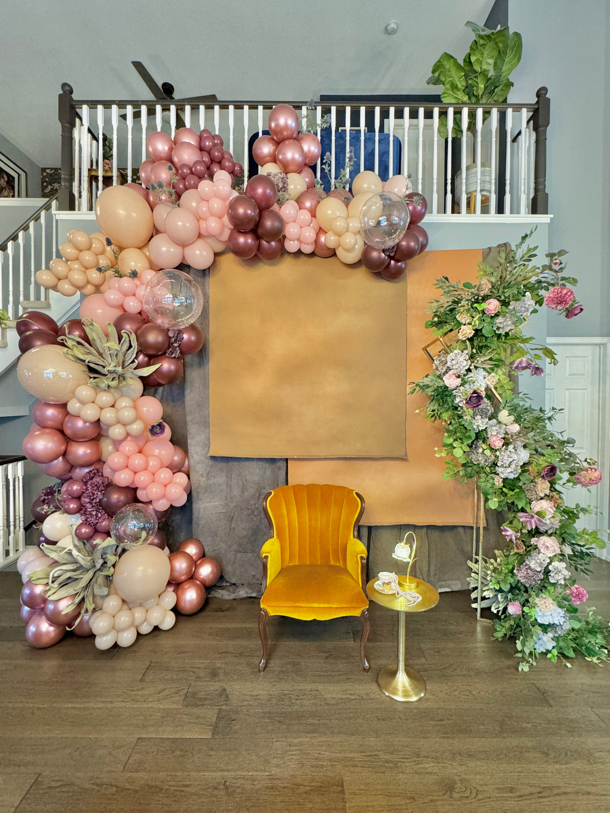 Luxury spring floral balloon garland with blush, gold, and greenery for elegant event decor.