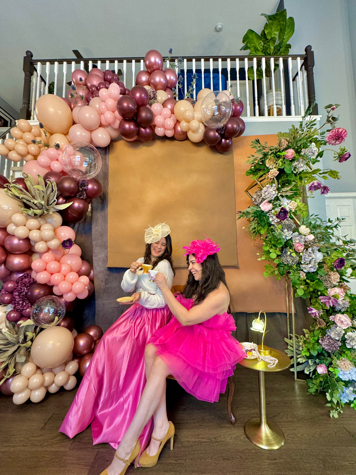 Luxury spring floral balloon garland with blush, gold, and greenery for elegant event decor.
