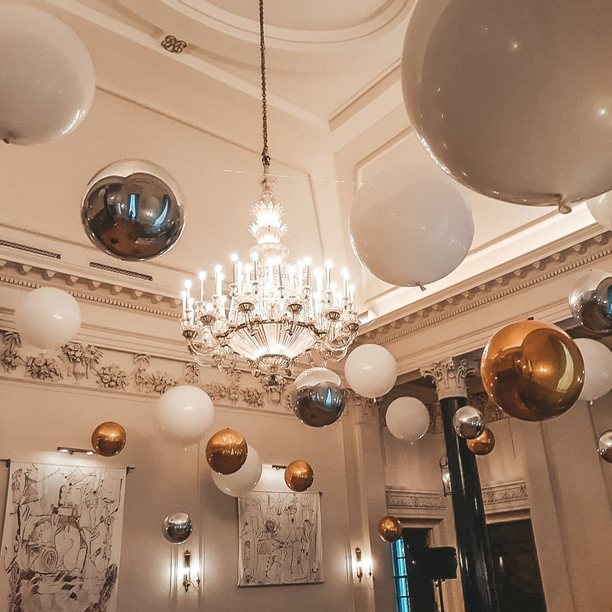 Suspended Floating Balloon Installation with giant and orbz balloons in a stunning event venue.