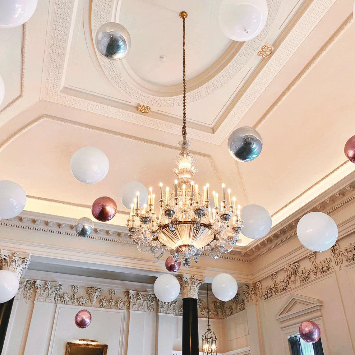 Suspended Floating Balloon Installation with giant and orbz balloons in a stunning event venue.