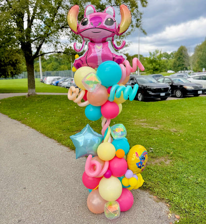 Angel birthday balloon column with pink, turquoise, yellow and peach balloons, spiral accents and a blue foil star by Wooow Balloons in Toronto.