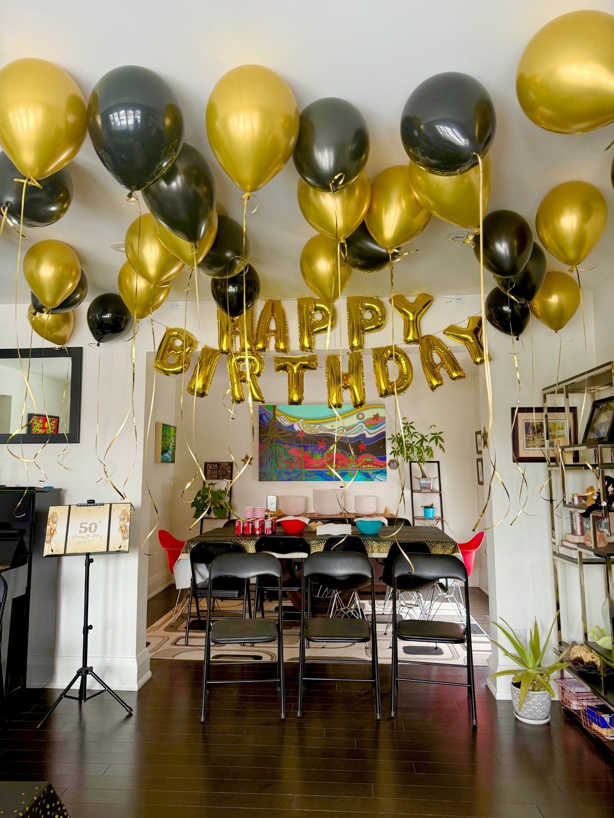 At-home birthday balloon room decor in gold and black tones, Toronto balloon setup by Wooow Balloons
