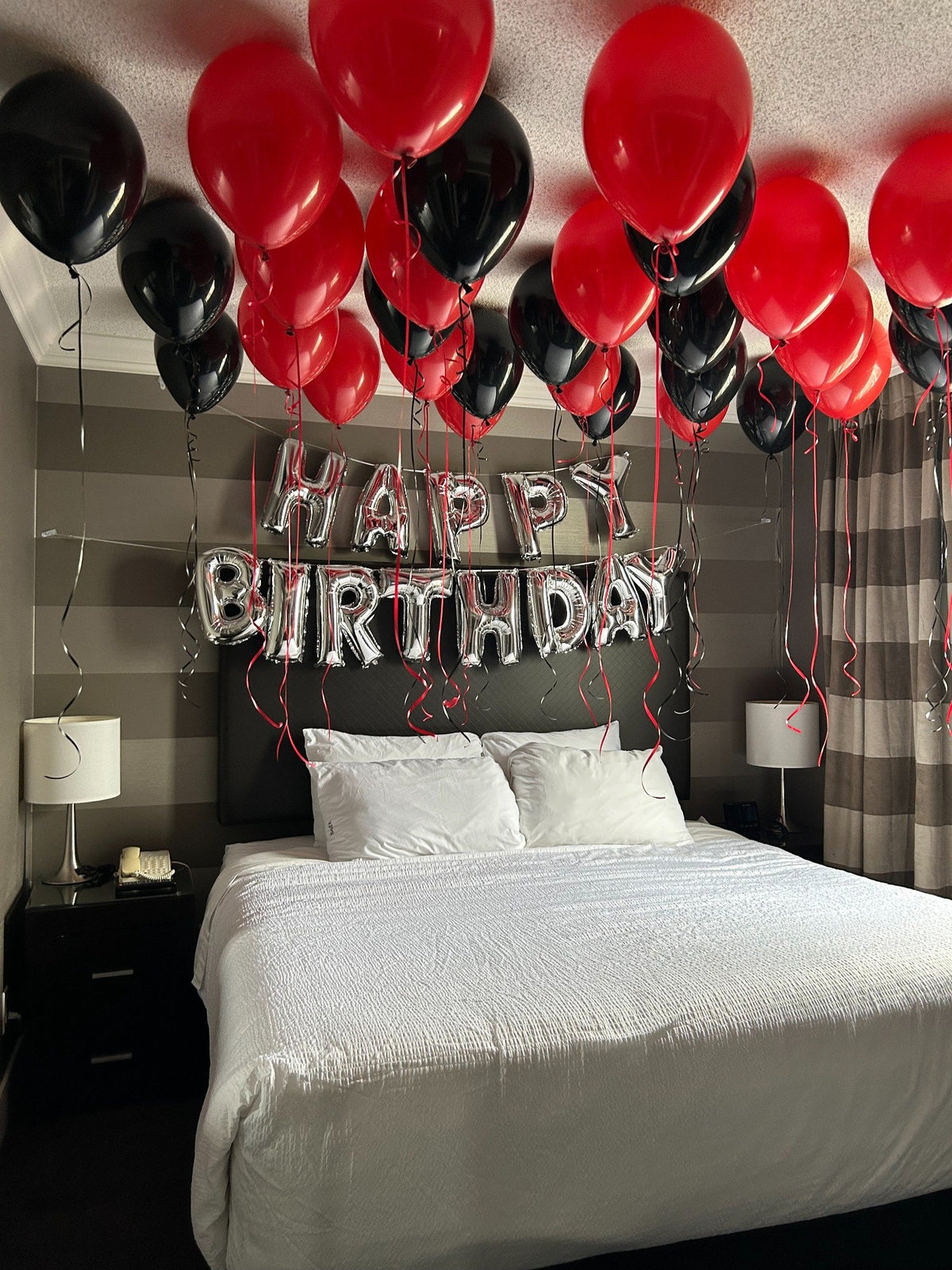 At-home birthday balloon room decoration in red and black colors, Toronto surprise balloon setup by Wooow Balloons
