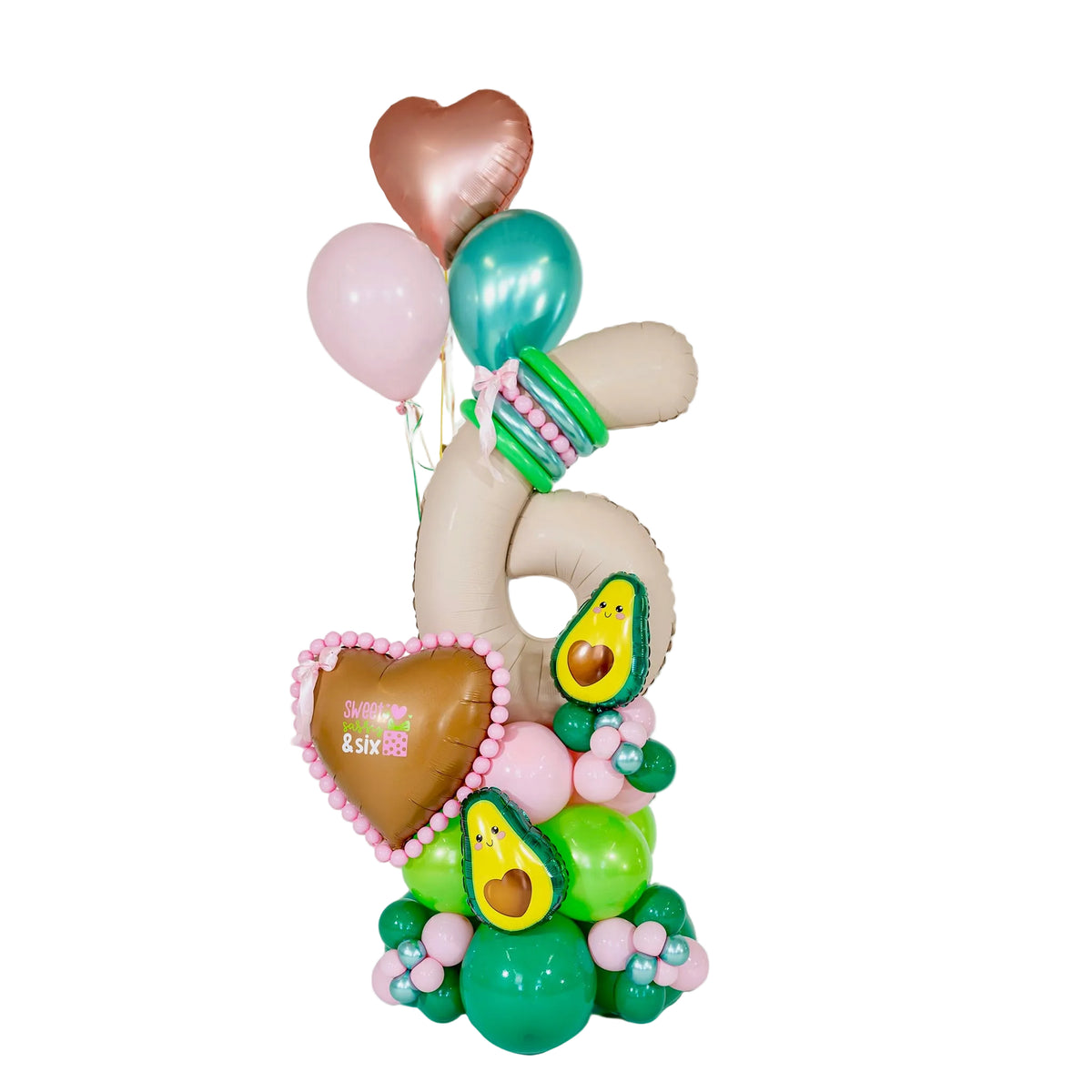 Avocado birthday balloons Toronto arrangement by Wooow Balloons with a cream number 6, pink and green balloon base, avocado characters and heart balloons.
