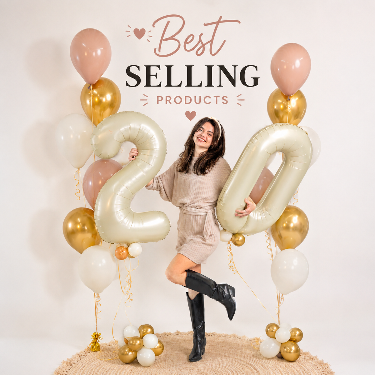 Woman holding gold number 20 balloons with gold and white balloon bouquets