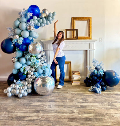 Custom-colour freestanding balloon garland with floral and metallic details for Toronto events.