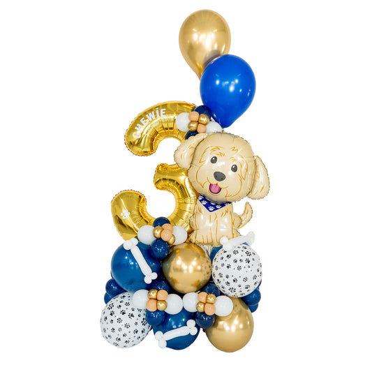 Personalized dog birthday balloon arrangement with a gold number 3, puppy foil balloon, blue and gold balloons, and paw-print details by Wooow Balloons in Toronto.
