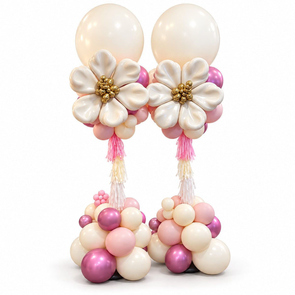 Two pink and cream balloon pillars with large cream balloon flowers, gold centres and cascading tassels by Wooow Balloons in Toronto.
