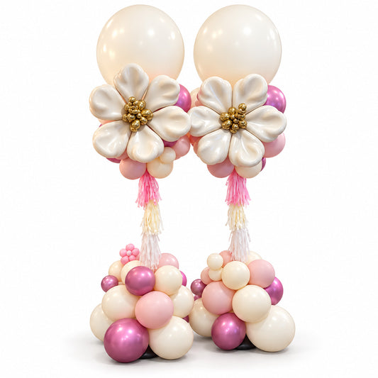Two pink and cream balloon pillars with large cream balloon flowers, gold centres and cascading tassels by Wooow Balloons in Toronto.
