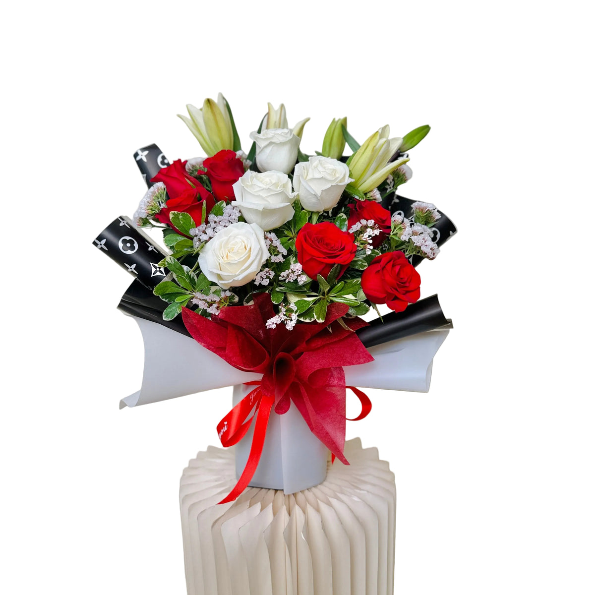 Fresh Mother’s Day bouquet with roses and lilies wrapped in luxury floral paper