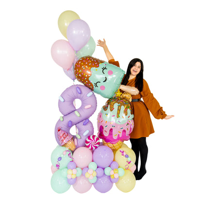 Ice cream balloon bouquet with a lavender number 8, ice pop and cone balloons, and pastel balloon flowers by Wooow Balloons in Toronto.