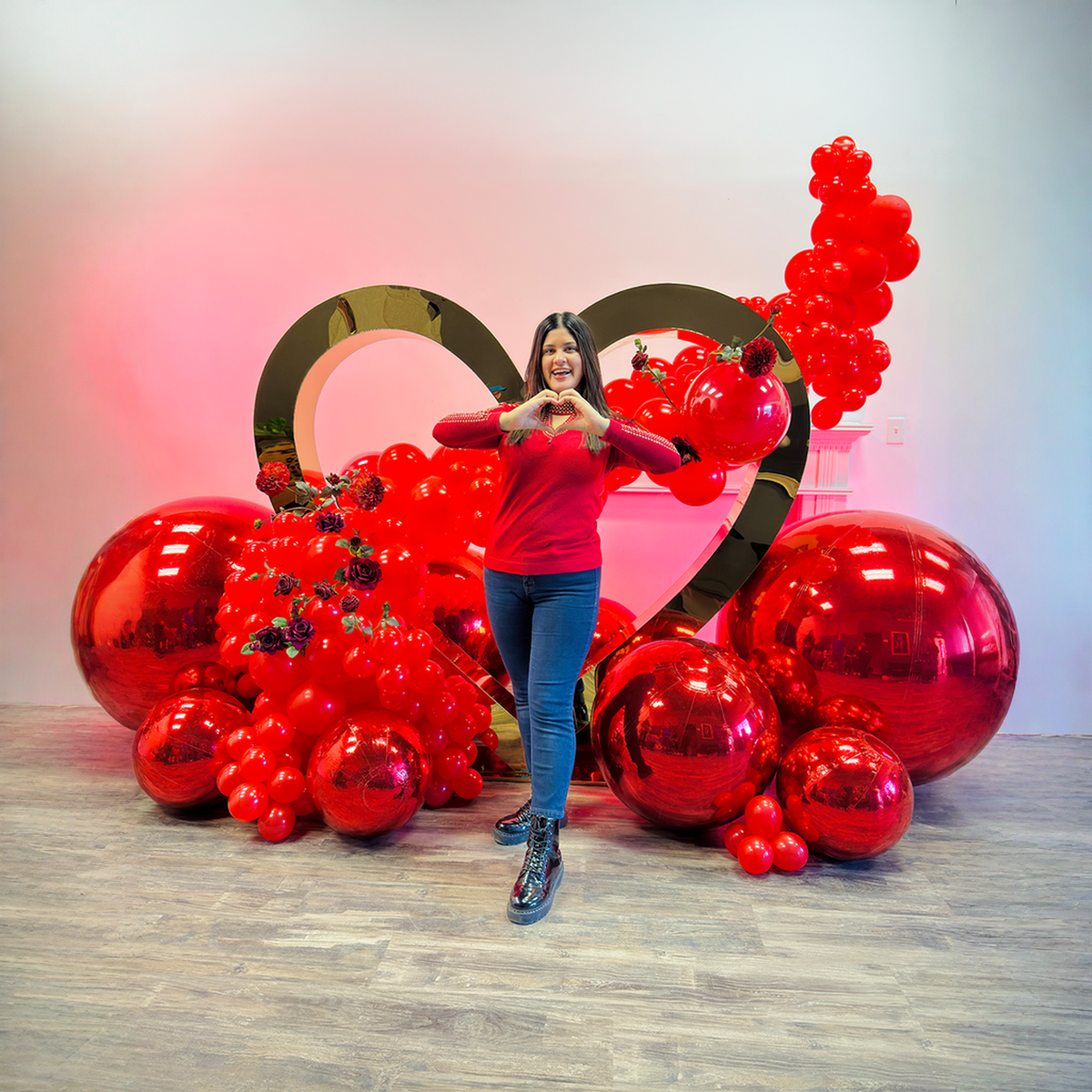Proposal balloon decoration Toronto featuring a luxury gold heart backdrop with red balloon garland and mirror balls