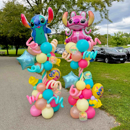 Stitch and Angel birthday balloon columns with turquoise, pink, yellow and peach balloons, blue stars and spiral accents by Wooow Balloons in Toronto.