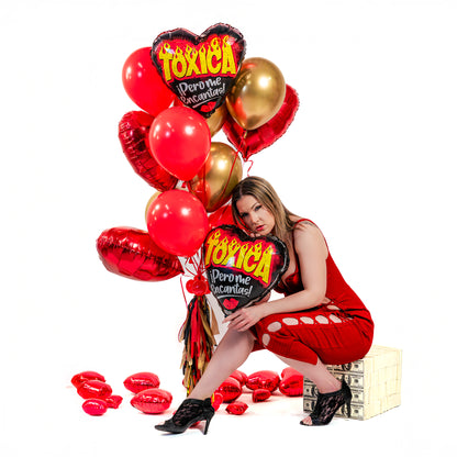 Toxica Pero Me Encantas Valentine balloon bouquet Toronto with red open-heart foil balloon, red hearts, gold balloons, and tassel weight.